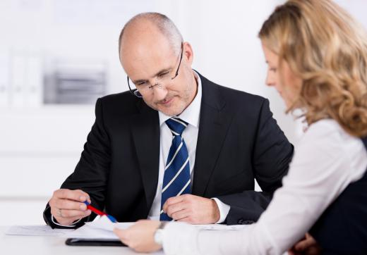 A loan originator evaluates loan applications and gathers information before financing a loan.