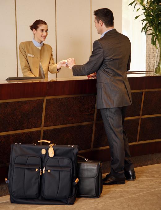 A hotel front desk agent is often responsible for checking guests in and out of the hotel.